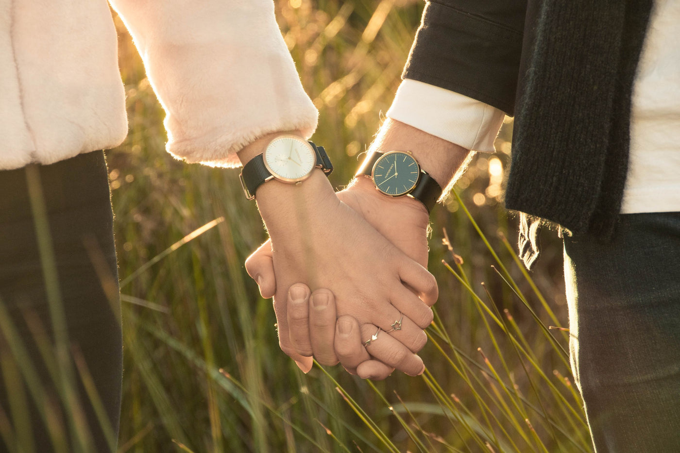 Man and woman holding hands wearing new watches