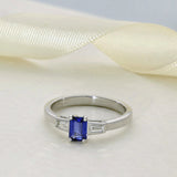 18ct White Gold 0.53ct Emerald Cut Sapphire and Tapered Baguette Diamond 3 Stone Ring