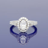 Platinum 0.71ct D SI1 Certificated Oval Cut Diamond Halo Ring with Diamond Set Shoulders