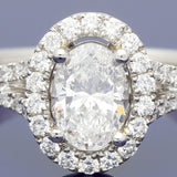 Platinum 0.71ct D SI1 Certificated Oval Cut Diamond Halo Ring with Diamond Set Shoulders
