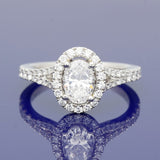 Platinum 0.71ct D SI1 Certificated Oval Cut Diamond Halo Ring with Diamond Set Shoulders