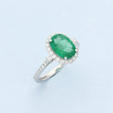 18ct White Gold Oval Emerald and Diamond Halo Cluster Ring with Diamond Shoulders