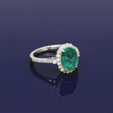 18ct White Gold Oval Emerald and Diamond Halo Cluster Ring with Diamond Shoulders