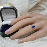 18ct Yellow Gold 0.61ct Emerald Cut Sapphire and 0.49ct Diamond 3 Stone Ring