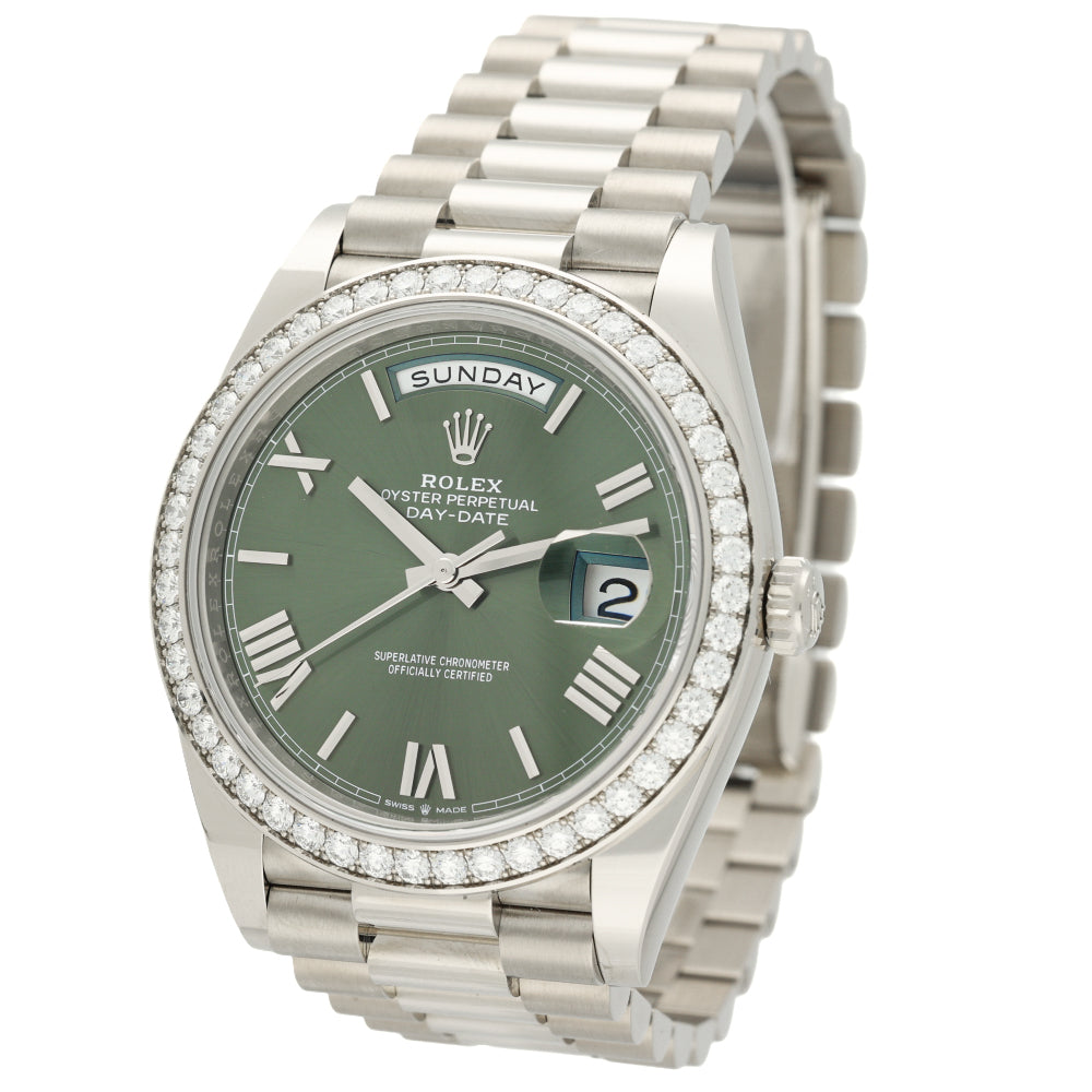Rolex Day-Date watch with a green dial, a diamond-encrusted bezel, and a stainless steel Oyster bracelet, shown on a white background.