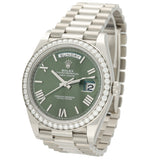 Rolex Day-Date watch with a green dial, a diamond-encrusted bezel, and a stainless steel Oyster bracelet, shown on a white background.