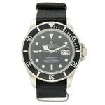 Rolex Submariner Date watch with a silver stainless steel case, black dial, black rotating bezel, and a black nylon strap, shown against a plain white background.