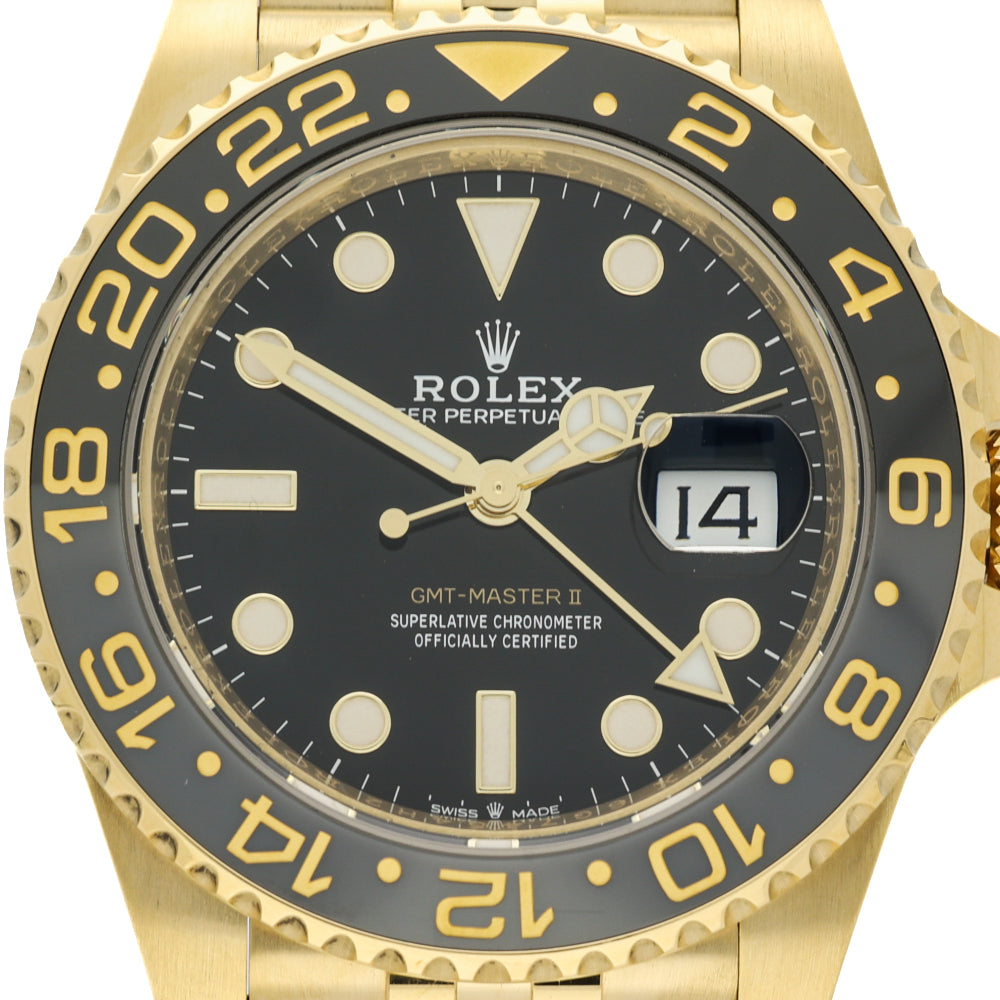 Rolex GMT-Master II wristwatch with a gold-tone case, black dial, and black bezel with gold numerals.