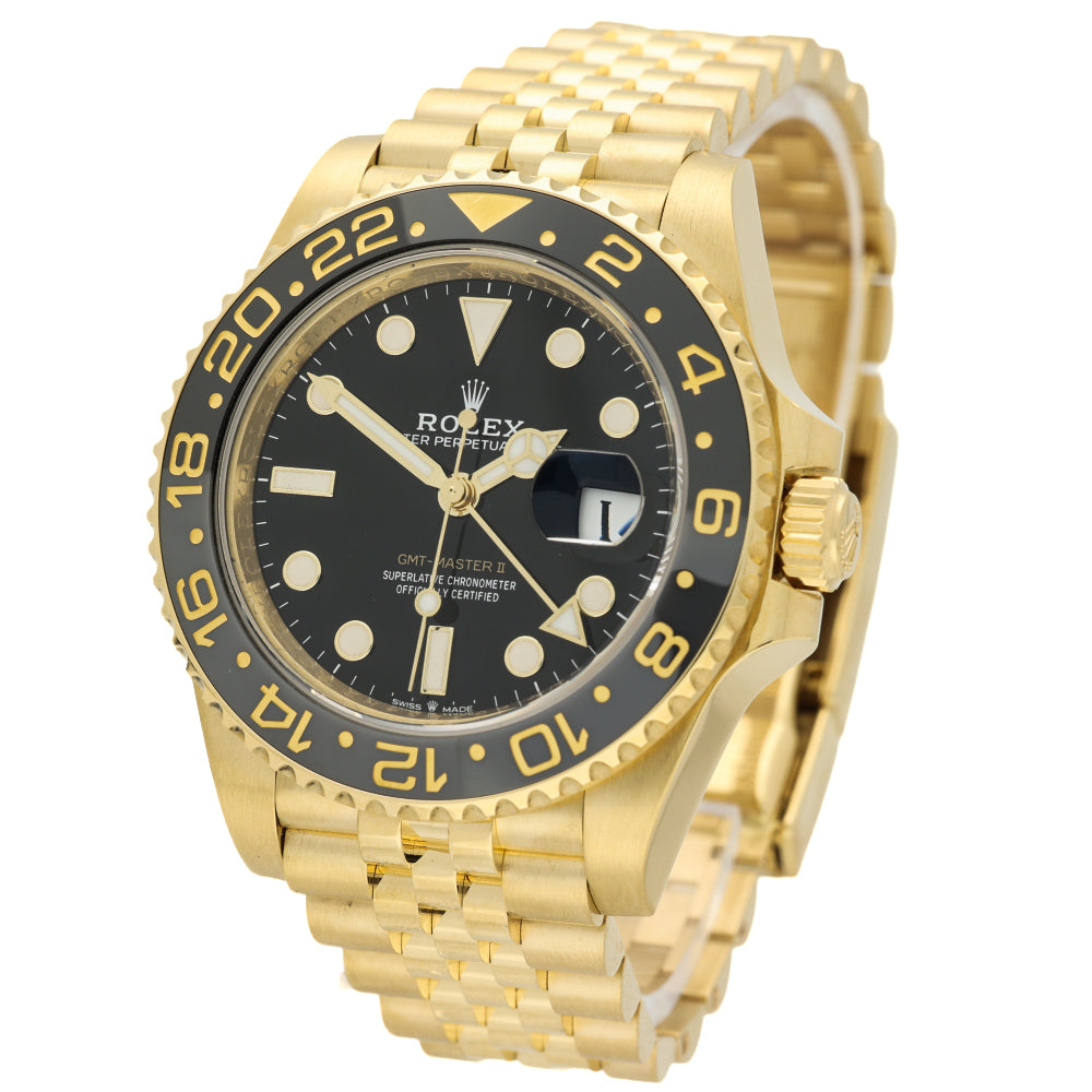 Rolex Submariner Date watch in yellow gold with a black dial and black rotating bezel, featuring a gold Oyster bracelet on a white background.