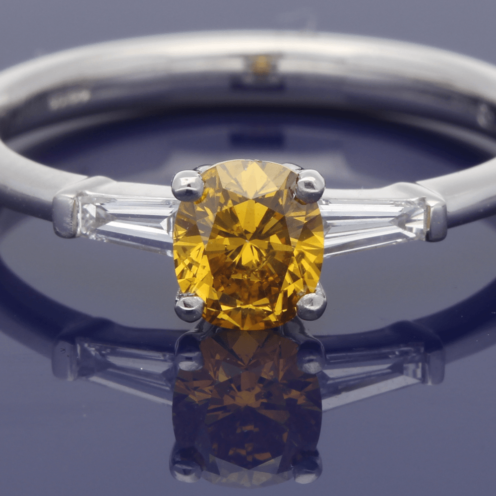 Platinum 0.54ct Certificated Fancy Natural Yellow Diamond Solitaire Ring with Tapered Baguette Set Shoulders