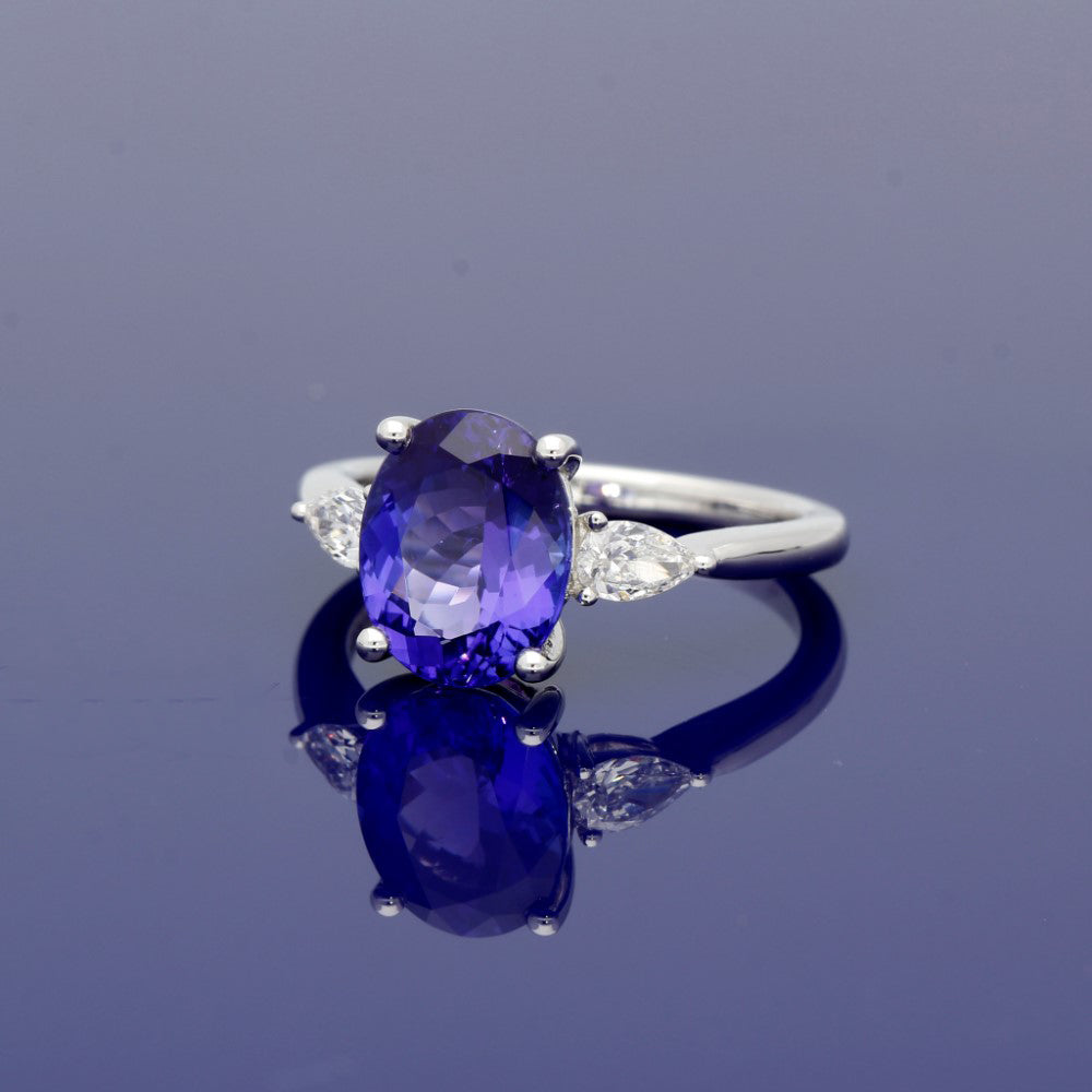 18ct White Gold Trilogy Ring with 3ct Tanzanite and Pear Shape Diamond Shoulders